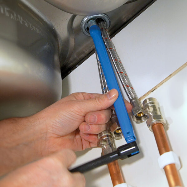 Tilting handle for use on basin tap-back nuts in confined spaces